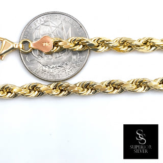 Superior Silver 10K yellow gold 5.3mm rope link chain with a lobster clasp shown next to a US quarter for scale