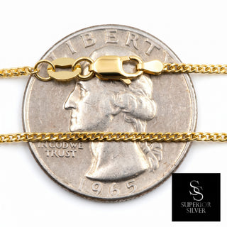 Superior Silver 10K yellow gold 1.0mm wheat chain necklace with a lobster clasp shown against a US quarter coin