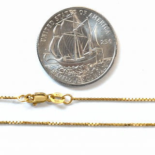 Superior Silver 14K yellow gold 0.9mm box link chain with spring ring clasp shown next to a US quarter for scale.
