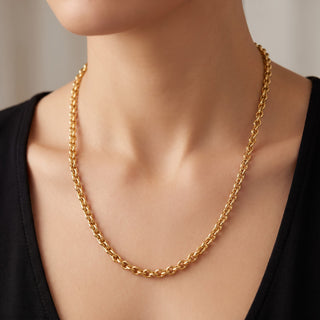 Superior Silver 20-inch solid 14K yellow gold heavy link chain necklace worn on a person with a black top.