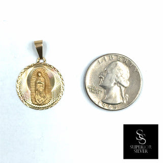 Superior Silver 14K yellow gold Mother Mary medallion pendant with diamond-cut detailing next to a US quarter coin.
