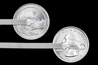 Superior Silver 3.3mm herringbone chain in polished 925 sterling silver shown against US quarters for scale