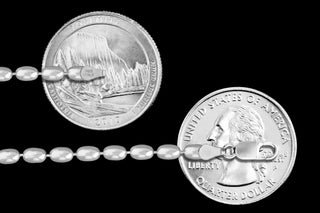 Superior Silver 3mm oval bead chain in 925 sterling silver with a lobster clasp, shown next to US quarters for scale.