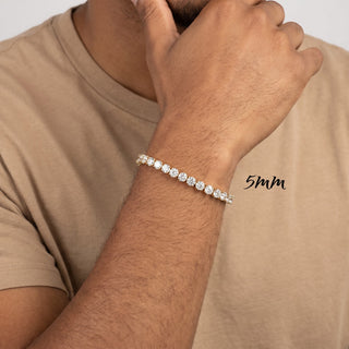 Superior Silver 5mm round brilliant moissanite tennis bracelet in gold vermeil worn on a man's wrist