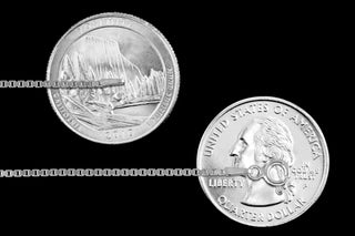 Superior Silver 1.3mm diamond-cut box chain in 925 sterling silver shown against US quarters for scale