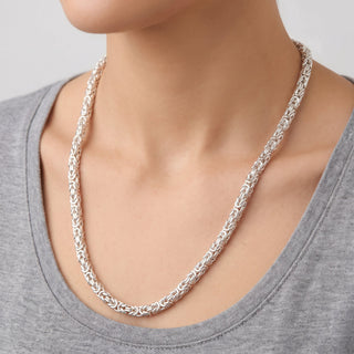 Superior Silver 24-inch flat Byzantine chain necklace in rhodium-plated 925 sterling silver worn on a model