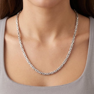Superior Silver 24-inch flat Byzantine link chain in polished rhodium over 925 sterling silver worn around the neck.