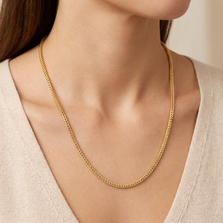 Superior Silver 24-inch Franco link chain in 14kt yellow gold over 925 sterling silver worn around a model's neck.