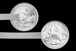 Superior Silver 7.2mm herringbone chain in 925 sterling silver with a lobster clasp, shown against US quarters.