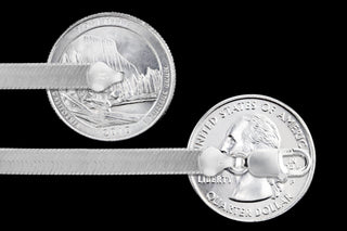 Superior Silver 5.4mm herringbone chain in polished 925 sterling silver with a lobster clasp, shown against coins.