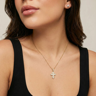 Superior Silver iced pave gothic cross pendant in gold vermeil with VVS D moissanite stones worn on a model