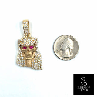 Superior Silver 14K yellow gold Jesus pendant featuring natural diamonds and genuine ruby eyes next to a US quarter.