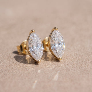 Superior Silver marquise cut moissanite stud earrings in yellow gold plated sterling silver with secure screw backs.