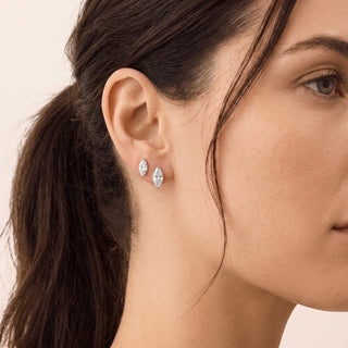 Superior Silver marquise cut moissanite stud earrings in sterling silver worn on a model's ear