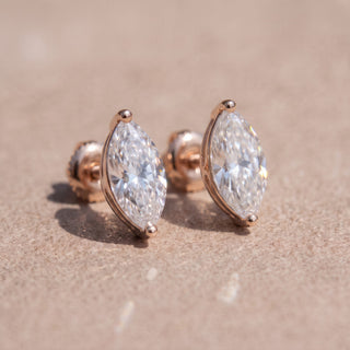 Superior Silver marquise-cut moissanite stud earrings in rose gold with secure screw backs on a neutral background.