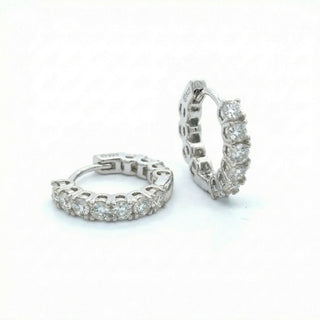 Superior Silver shared prong eternity hoop earrings in 925 sterling silver with sparkling VVS D color moissanite stones.