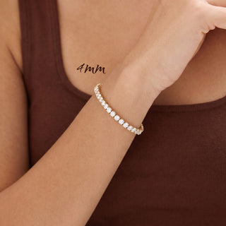 Superior Silver 4mm round brilliant moissanite tennis bracelet in gold vermeil worn on a woman's wrist