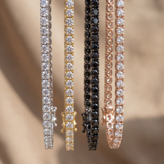 Superior Silver round brilliant moissanite tennis bracelets in silver, gold, black rhodium, and rose gold finishes.