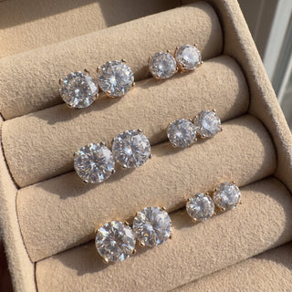Superior Silver Portuguese cut moissanite stud earrings in various sizes, set in gold vermeil, displayed in a box.