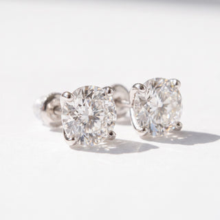 Superior Silver Portuguese cut moissanite stud earrings in white gold vermeil with a four-prong setting.