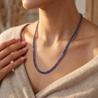 Superior Silver round cut blue sapphire tennis chain in 925 sterling silver worn on a model.