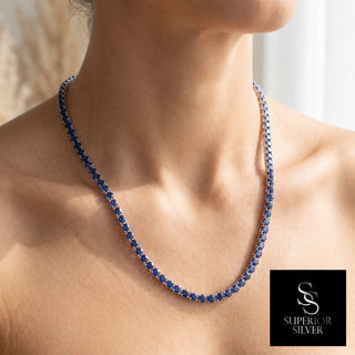 Superior Silver round cut blue sapphire tennis chain in 925 sterling silver, worn view around the neck.