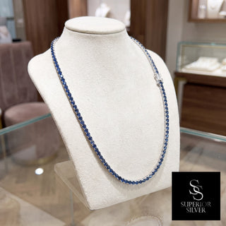 Superior Silver round cut blue sapphire tennis chain in 925 sterling silver displayed on a jewelry bust.
