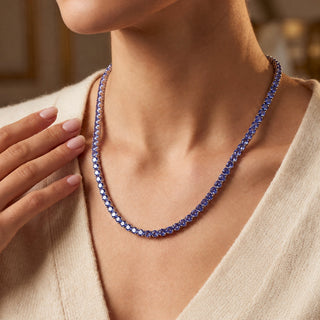Superior Silver round cut tanzanite tennis chain in 925 sterling silver worn on a model.
