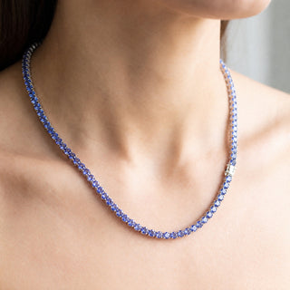 Superior Silver round cut tanzanite tennis chain in 925 sterling silver, worn view of the blue violet stones.