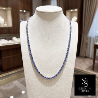 Superior Silver round cut tanzanite tennis chain in 925 sterling silver displayed on a jewelry bust.