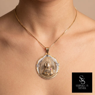 Superior Silver 10K yellow gold Santa Barbara pendant featuring a ruby accent and diamond-cut detailing on a model.