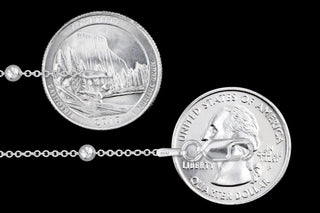 Superior Silver 1.2mm sterling silver cable bead chain with lobster clasp shown against US quarter coins for scale.