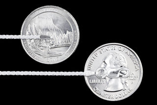 Superior Silver 1.8mm sterling silver criss cross chain with lobster clasp shown next to a US quarter for scale.