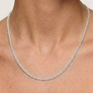 Superior Silver sterling silver love chain necklace with an interlocking link design worn around a person's neck.