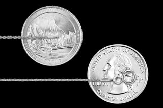 Superior Silver 1.1mm sterling silver rope chain shown against two US quarters for scale on a black background.