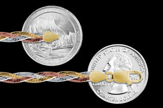 Superior Silver 5mm 3-braid herringbone chain in tri-color sterling silver with a lobster clasp, shown against coins.