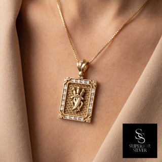 Superior Silver triple sword pendant in 10K yellow gold with CZ stones and diamond-cut detailing worn on a chain