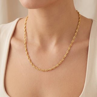 Superior Silver 20-inch twisted Cuban link chain in 14kt yellow gold over 925 sterling silver worn on a model