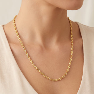 Superior Silver 24-inch twisted Cuban link chain in 14kt yellow gold over 925 sterling silver worn on a model