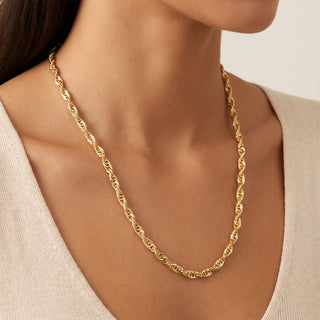 Superior Silver 22-inch twisted Cuban link chain in 14kt yellow gold over 925 sterling silver worn on a model