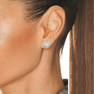 Tiered Pavé Heart Moissanite Stud Earrings in sterling silver, worn on model