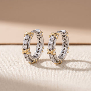 Two tone 10mm slim moissanite X motif huggie hoop earrings, macro detail