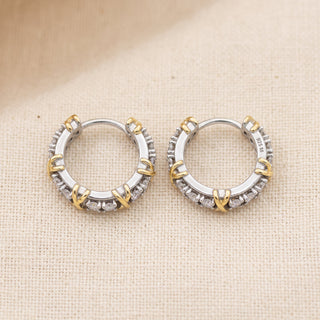 Two tone 10mm slim moissanite X motif huggie hoop earrings, macro detail of the X motif