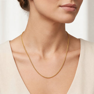 Superior Silver 18-inch 10K yellow gold wheat chain necklace with a smooth braided weave worn on a model