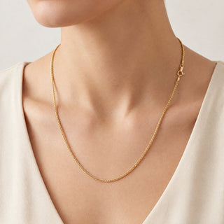 Superior Silver 18-inch 10K yellow gold wheat chain necklace with a lobster clasp worn on a model