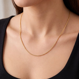 Superior Silver 18-inch 10K yellow gold wheat chain necklace with a delicate 1.0mm braided weave worn on a model.